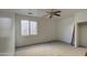 Cozy bedroom with a ceiling fan, closet, and a bright window at 1016 E Saddleback Pl, San Tan Valley, AZ 85143