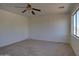 Bedroom features a large window, neutral carpet, and white walls at 1016 E Saddleback Pl, San Tan Valley, AZ 85143