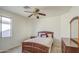 Comfortable bedroom features a ceiling fan and ample natural light from the window at 1016 E Saddleback Pl, San Tan Valley, AZ 85143