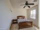 Bedroom showcases a wood bed frame and natural light from the window at 1016 E Saddleback Pl, San Tan Valley, AZ 85143