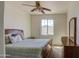 Comfortable bedroom features a wood frame bed and natural light at 1016 E Saddleback Pl, San Tan Valley, AZ 85143