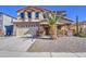 Charming two-story home with a well-manicured lawn and beautiful landscaping, including a palm tree at 1016 E Saddleback Pl, San Tan Valley, AZ 85143