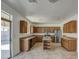 A large kitchen with ample counter space, central island, and stainless steel appliances at 1016 E Saddleback Pl, San Tan Valley, AZ 85143