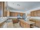 Spacious kitchen featuring wood cabinetry, a central island, and stainless steel appliances at 1016 E Saddleback Pl, San Tan Valley, AZ 85143