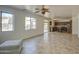 Bright living area showing the tile flooring, windows, and ceiling fan at 1016 E Saddleback Pl, San Tan Valley, AZ 85143