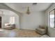 Bright living room featuring tile floors, a decorative chandelier, and a comfortable sofa at 1016 E Saddleback Pl, San Tan Valley, AZ 85143