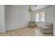 Bright living room featuring tile floors, a decorative chandelier, and two comfortable chairs at 1016 E Saddleback Pl, San Tan Valley, AZ 85143