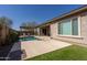 Backyard showcasing the pool, artificial grass, and extended patio with a pergola, ideal for outdoor relaxation at 10657 E Evergreen St, Mesa, AZ 85207