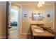 Bathroom featuring double sinks and granite countertops, plus view to another room at 10657 E Evergreen St, Mesa, AZ 85207