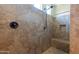 Walk-in shower featuring neutral tile, rainfall shower head and a bench at 10657 E Evergreen St, Mesa, AZ 85207