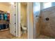 Bathroom with walk in shower, toilet and door to a walk in closet at 10657 E Evergreen St, Mesa, AZ 85207