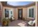 Enclosed courtyard with brick flooring, seating, and an entryway to the house at 10657 E Evergreen St, Mesa, AZ 85207