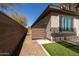 Home exterior featuring gravel yard and artificial grass with outdoor shower and covered patio at 10657 E Evergreen St, Mesa, AZ 85207