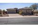 Inviting single-story home featuring a brick driveway, stone accents, and a two-car garage at 10657 E Evergreen St, Mesa, AZ 85207