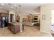 Open-concept living room with the kitchen, tile flooring and natural light at 10657 E Evergreen St, Mesa, AZ 85207