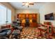 A home office with a built-in wooden desk and colorful rug at 10657 E Evergreen St, Mesa, AZ 85207