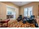 Home office with colorful rug and two black recliner chairs at 10657 E Evergreen St, Mesa, AZ 85207