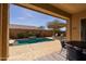 Inviting backyard pool with a tranquil water feature and a covered patio with lounge chairs at 10657 E Evergreen St, Mesa, AZ 85207