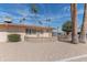 Single-story home with desert landscaping, brick accents, and palm trees at 10701 W Mountain View Rd, Sun City, AZ 85351