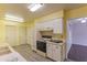 Bright kitchen featuring white cabinetry, modern appliances, and an open layout at 10701 W Mountain View Rd, Sun City, AZ 85351