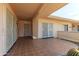 A covered patio with tiled flooring, providing a cozy outdoor space at 10701 W Mountain View Rd, Sun City, AZ 85351