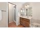 Neutral bathroom with shower, decorative mirror, and wooden vanity at 11413 E Neville Ave, Mesa, AZ 85209