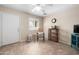 Bright bonus room is shown with chair, shelving and a ceiling fan at 11413 E Neville Ave, Mesa, AZ 85209