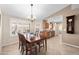 Inviting dining room features a classic wood table, chandelier, and bright windows at 11413 E Neville Ave, Mesa, AZ 85209