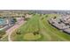 Scenic aerial view of a lush golf course with palm trees and well-manicured greens at 11413 E Neville Ave, Mesa, AZ 85209