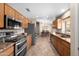 Open kitchen design flows to dining area, showcasing stainless appliances and oak cabinets at 11413 E Neville Ave, Mesa, AZ 85209