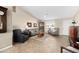 Spacious living room featuring a vaulted ceiling, tile floors, and abundant natural light at 11413 E Neville Ave, Mesa, AZ 85209