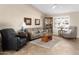 Cozy living room with neutral paint, tile flooring, and a bright window with charming decor at 11413 E Neville Ave, Mesa, AZ 85209