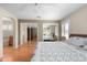 Comfortable main bedroom with ceiling fan, ensuite bathroom, mirrored closets and light hardwood floors at 11413 E Neville Ave, Mesa, AZ 85209