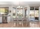 Bright and airy dining area with large windows, a modern chandelier, and easy access to the patio at 1202 E Desert Broom Way, Phoenix, AZ 85048