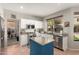 Modern kitchen with white cabinets, granite countertops, and a blue island at 1202 E Desert Broom Way, Phoenix, AZ 85048