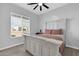 Bright bedroom features a distressed wood frame bed and natural light from a large window at 1291 E La Fortuna Ct, San Tan Valley, AZ 85140