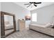 Neutral-toned bedroom showcasing a cozy bed, a ceiling fan, and a large window at 1291 E La Fortuna Ct, San Tan Valley, AZ 85140