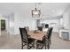 This dining area features a wooden table with seating for six and modern lighting fixtures at 1291 E La Fortuna Ct, San Tan Valley, AZ 85140