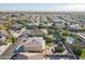 Expansive aerial view of a neighborhood showcasing homes with pools, solar panels and manicured landscaping at 12925 W Llano Dr, Litchfield Park, AZ 85340