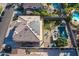 Aerial view of house featuring solar panels, pool, covered patio, and grassy area at 12925 W Llano Dr, Litchfield Park, AZ 85340