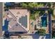 Aerial view of a backyard oasis with a pool, solar panels, and stylish outdoor seating at 12925 W Llano Dr, Litchfield Park, AZ 85340