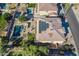 Aerial view of backyard featuring pool, solar panels, grassy area, and covered patio at 12925 W Llano Dr, Litchfield Park, AZ 85340