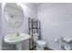 Charming powder room with a decorative mirror, pedestal sink, and toilet at 12925 W Llano Dr, Litchfield Park, AZ 85340