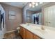 Bathroom featuring double sinks with gold fixtures and a shower with cat shower curtain at 12925 W Llano Dr, Litchfield Park, AZ 85340