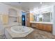 Bright bathroom featuring a spa tub and vanity with ample storage, creating a luxurious atmosphere at 12925 W Llano Dr, Litchfield Park, AZ 85340