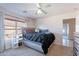 Bright bedroom featuring a bed, ceiling fan and natural light from the window at 12925 W Llano Dr, Litchfield Park, AZ 85340