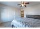 Spacious bedroom featuring carpeted floors, closet, ceiling fan, and natural light at 12925 W Llano Dr, Litchfield Park, AZ 85340