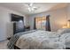 Comfortable bedroom with a ceiling fan and a view through the window to the outside patio at 12925 W Llano Dr, Litchfield Park, AZ 85340