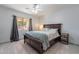 Cozy bedroom with a ceiling fan and a dark wood bed frame at 12925 W Llano Dr, Litchfield Park, AZ 85340