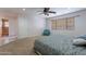 Comfortable bedroom featuring neutral walls, carpet, ceiling fan, and window with blinds at 12925 W Llano Dr, Litchfield Park, AZ 85340